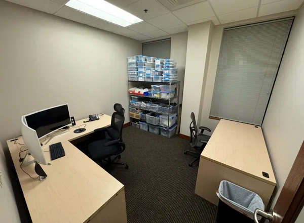Office desks assembled and set up with chairs and storage shelving