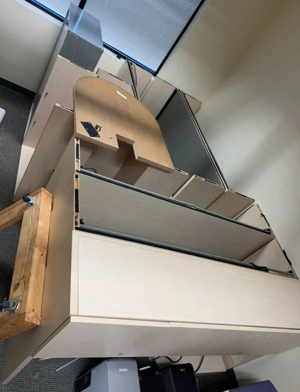 Disassembled office furniture grouped together with a furniture dolly