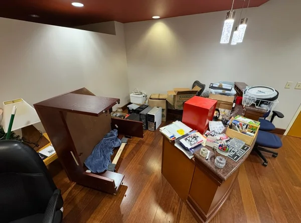 Reception desk sections, boxes and office items filling a reception area